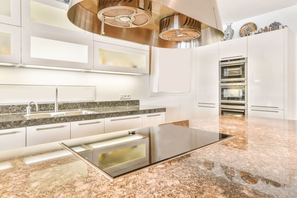 Close-up of polished granite countertop in a modern kitchen.