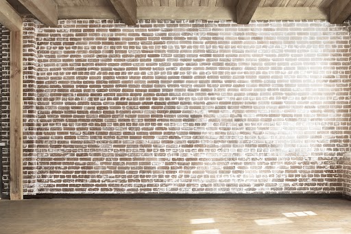 A wall with a German Schmear brick finish showcasing its rustic texture and timeless appeal